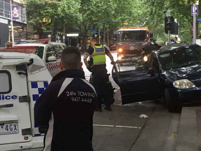 The car remains wedged on the footpath blocked in by three police vehicles. Picture: Aneeka Simonis