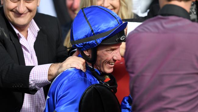 Jockey Jim Byrne is congratulated by owners after riding Capital Gain to win race 6, the J.J Atkins, during Stradbroke Day at Doomben racecourse in Brisbane, Saturday, June 10, 2017. (AAP Image/Dan Peled) NO ARCHIVING, EDITORIAL USE ONLY