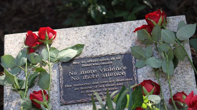 Red roses surround the plaque dedicated to Queenslanders lost to domestic violence. . Picture: Sherele Moody