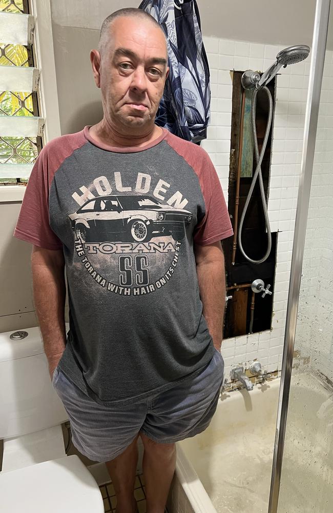 Greg Conroy in the bathroom of his Southport home where deadly asbestos sheeting was exposed. Picture: Keith Woods.