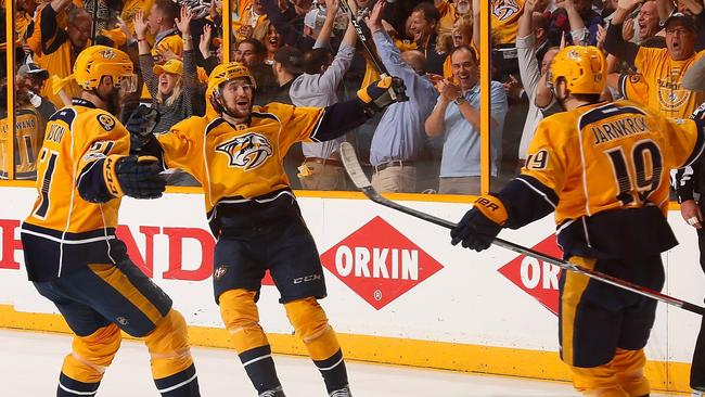 Austin Watson #51 and Filip Forsberg #9, congratulate teammate Calle Jarnkrok #19 on scoring an open net goal against the St. Louis Blues.