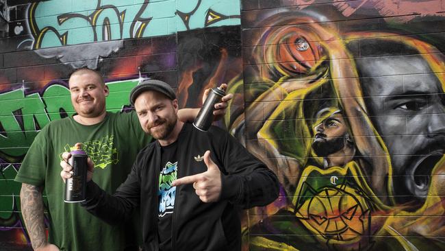 Street artist Rhys Williams and youth worker Joel Imber with their tribute to Jack McVeigh. Picture: Chris Kidd