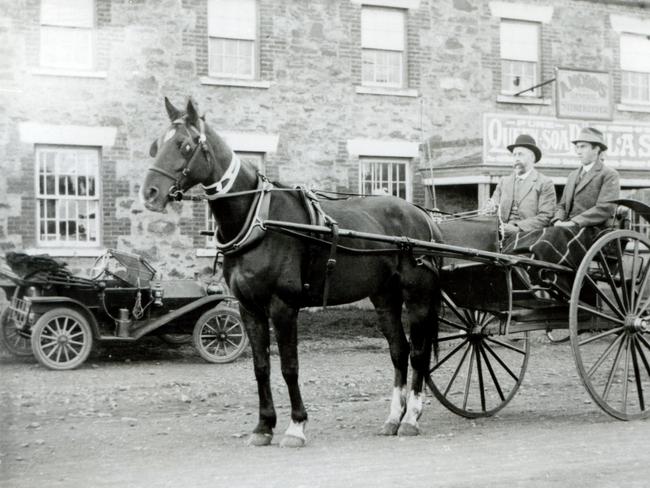 Mr Bayles and son Basil in their sulky outside the General Store in Swansea, Tasmania. Picture: COURTESY OF GLAMORGAN SPRING BAY HISTORICAL SOCIETY/MAUREEN FERRIS