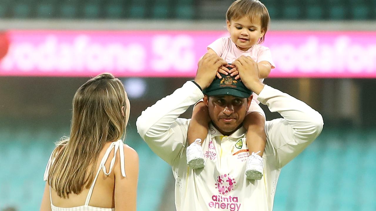 Usman Khawaja speaks to his wife while holding their daughter Aisha Khawaja during day five of the fourth Test of the Ashes. Getty