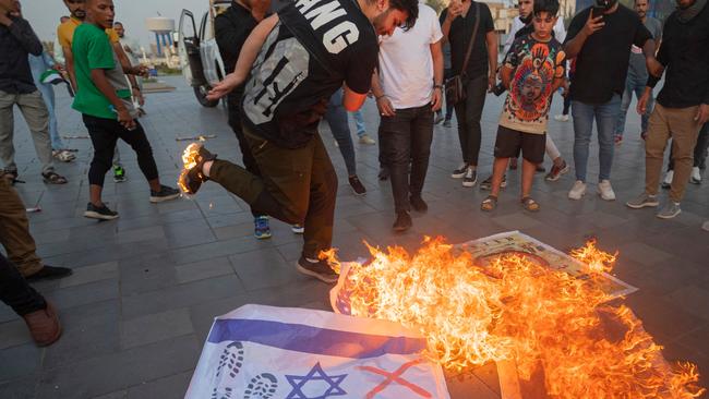 Iraqis burn Israeli flags during a rally held in central Baghdad in support of the Palestinians, after Hamas militants launched a deadly air, land and sea assault into Israel. Picture: AFP