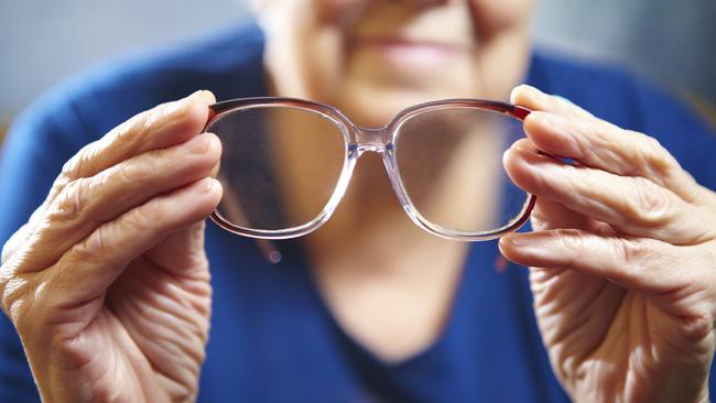 Old woman hands with eyeglasses. Senior people health care. Feeling Great - March 7