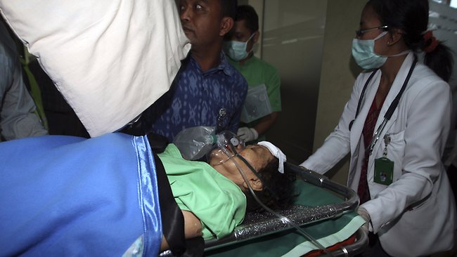 A passenger injured in a plane crash on a stretcher is carried for a medical treatment at a hospital in Jimbarn, Bali, Indonesia.