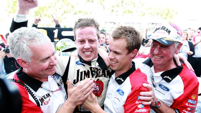 James Courtney celebrates his 2010 championship win with his team – Sydney Telstra 500, 2010 V8 Supercars Grand Finale, Sydney Olympic Park.