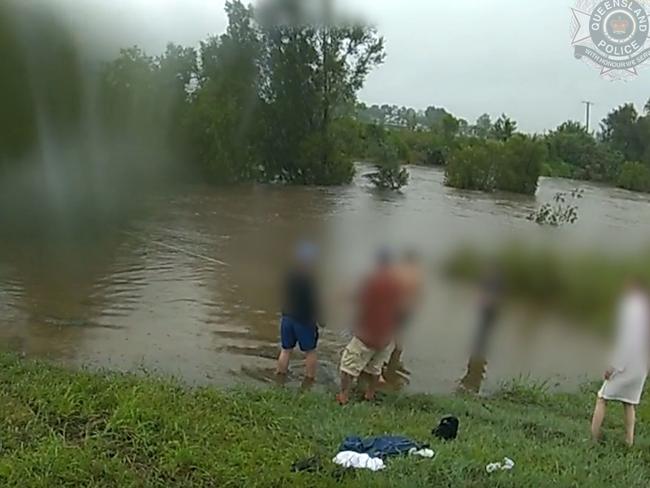 Dramatic footage shows the moment a woman was rescued from a car trapped among the trees trying to escape the rapidly rising water. Picture: Queensland Police