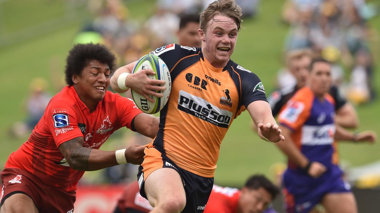 Brumbies player Ryan Lonergan is chased by Sunwolves player Garth April.