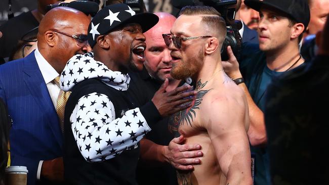 Floyd Mayweather Jr. and Conor McGregor face off during their London media conference.