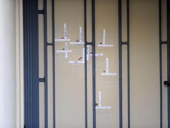 Bullet holes in the screen and door of a Gilles Plains house, after a man was shot just after midnight. Picture: Greg Higgs