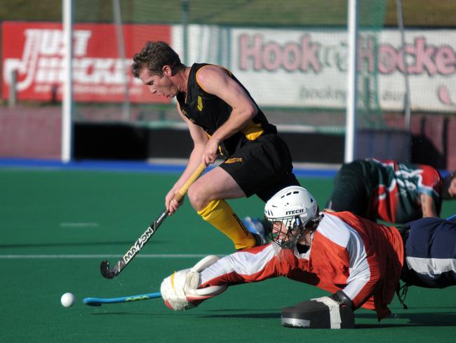 Mark Harris battles with a goalkeeper during his time playing in the Brisbane Hockey League. Photo Lee Oliver