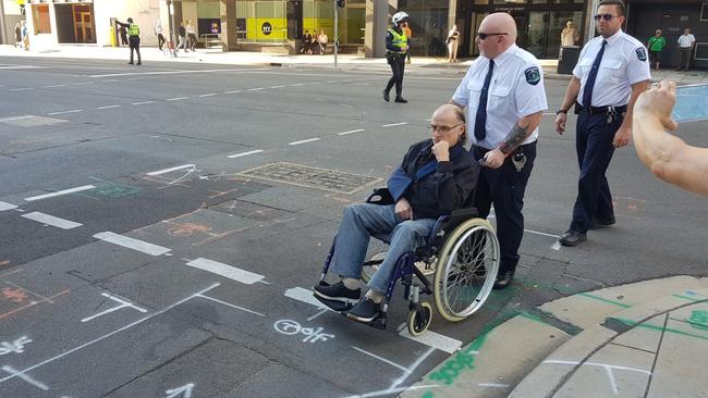 Court sheriff’s offices escort Perre from Franklin Street on to Bentham Street. Picture: Sean Fewster