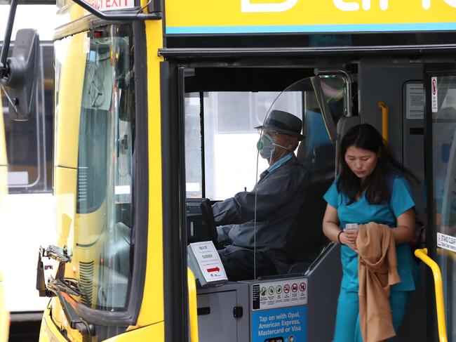 Bus drivers pictured wearing face masks this morning near the Wynyard bus interchange. Picture: David Swift.