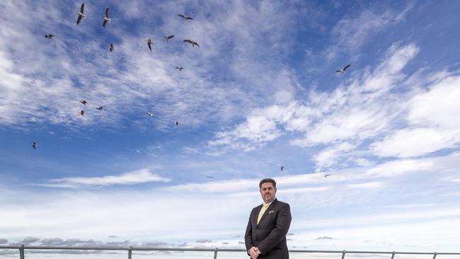 Dandenong Mayor Jim Memeti on the rooftop of the Greater Dandenong Council offices surrounded by gulls. Picture: Daniel Pockett