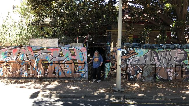 Wells’ well-known psychedelic fence and the old fig tree.