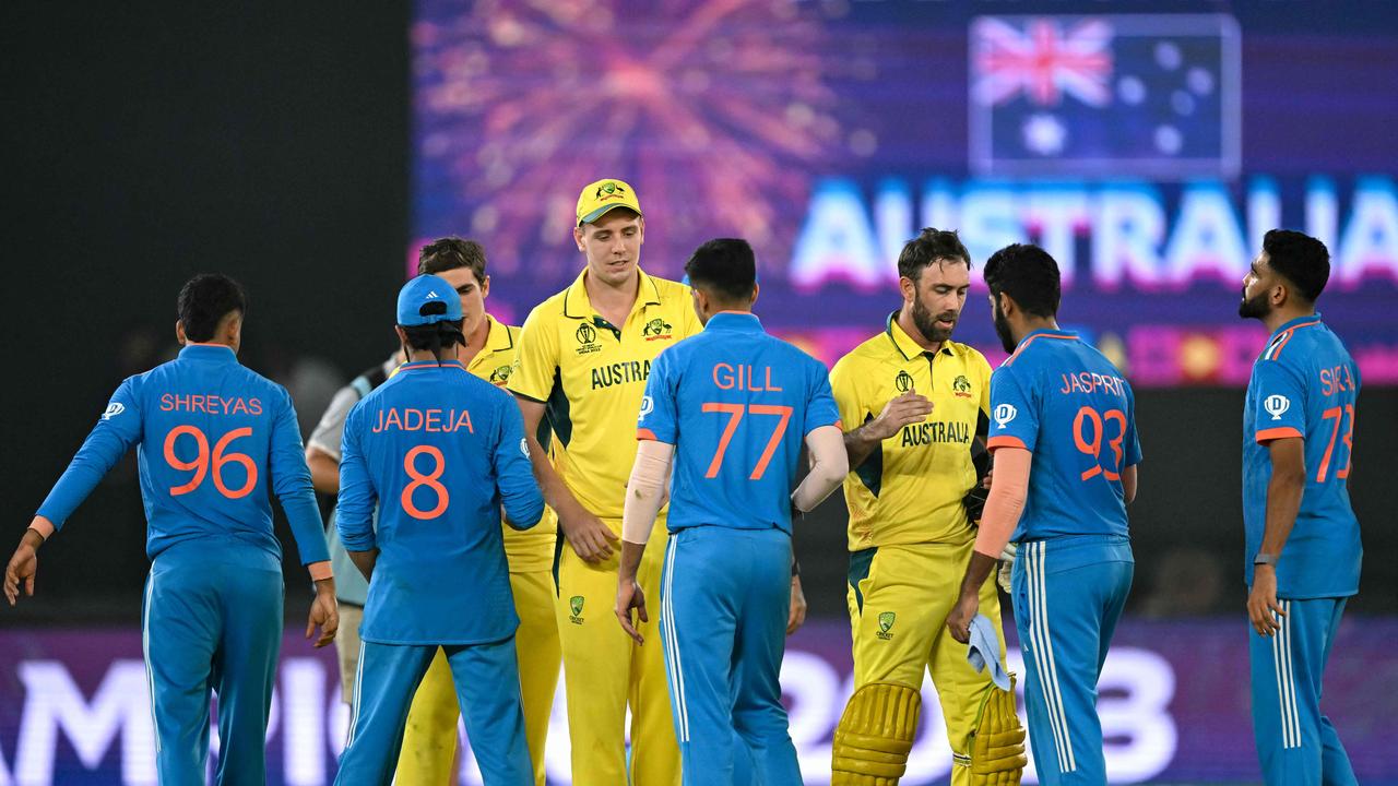 India and Australia players greet each other at the end of the match. Photo by Sajjad HUSSAIN / AFP.