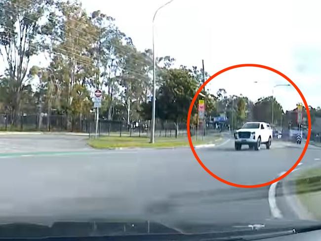 A ute pictured driving on the wrong side of the road outside Helensvale State High School. Picture: Monterey Keys Community Group / Facebook.