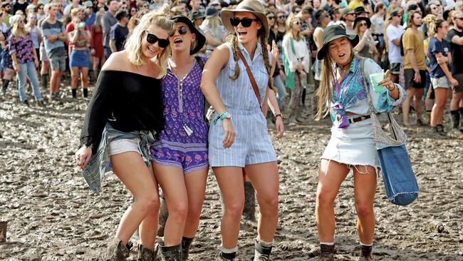 The mud didn't worry Lily Denman, Tayla Langley, Katie McCleary and Christie Moloney at Splendour in the Grass last year. Pic by Luke Marsden.