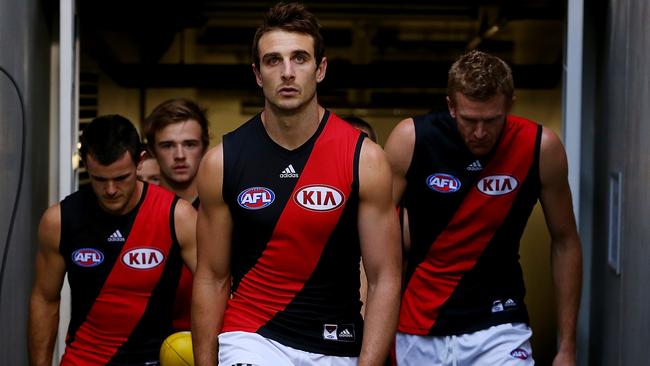 BRISBANE, AUSTRALIA - MAY 10: Jobe Watson of the Bombers leads the team out for the round eight AFL match between the Brisbane Lions and the Essendon Bombers at The Gabba on May 10, 2014 in Brisbane, Australia. (Photo by Chris Hyde/Getty Images)