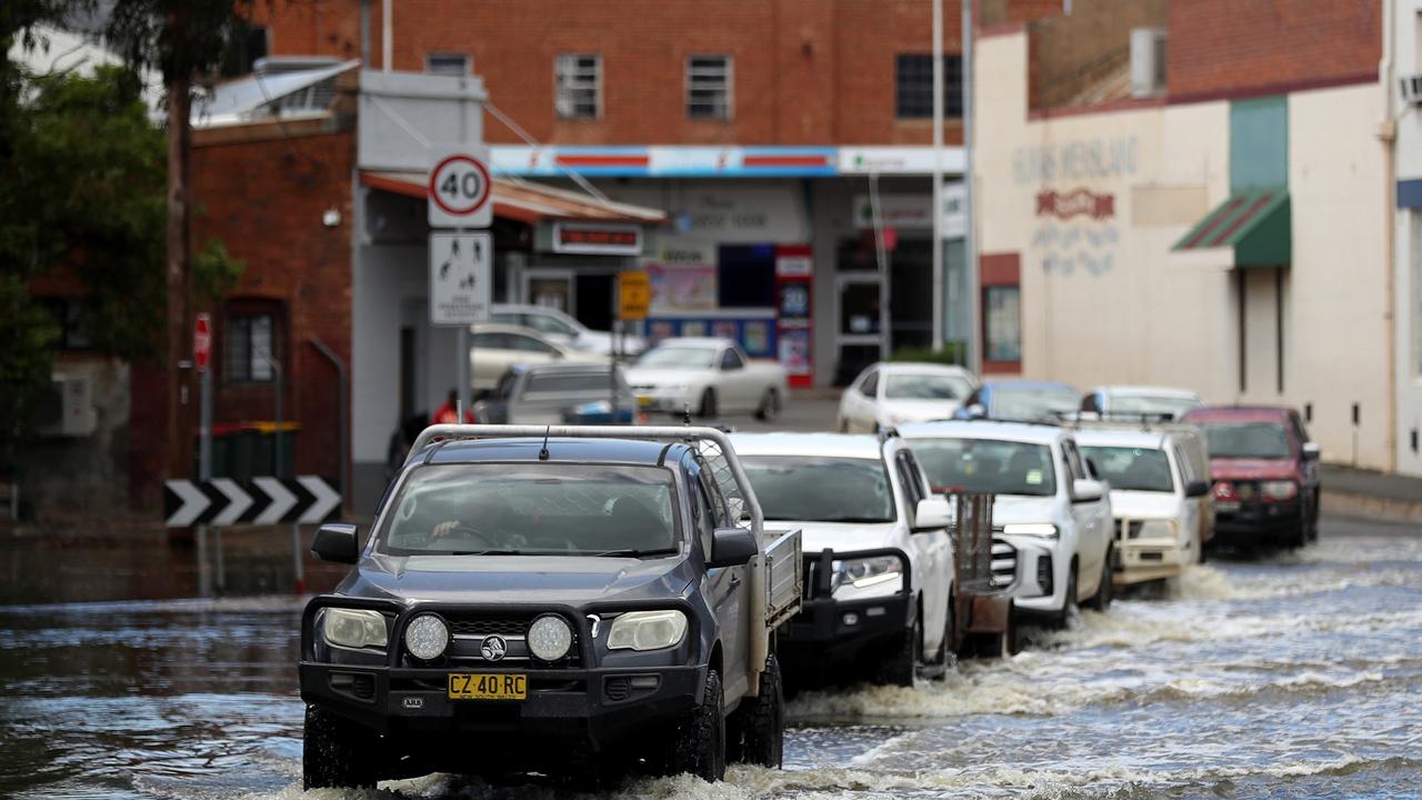 Cars drive through flood waters on November 4 in Forbes, Australia. Picture: Brendon Thorne / Getty Images / POOL / NCA NewsWire