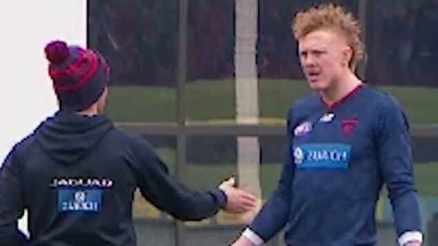 Melbourne midfielder Clayton Oliver in a heated discussion with a Dees trainer on Wednesday