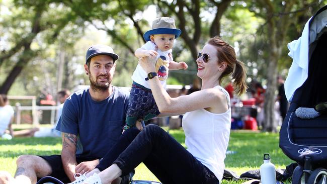 Isaac and Eliza Cook with their 8 month-old Ruben relaxing at Edinburgh Gardens in North Fitzroy in Melbourne.