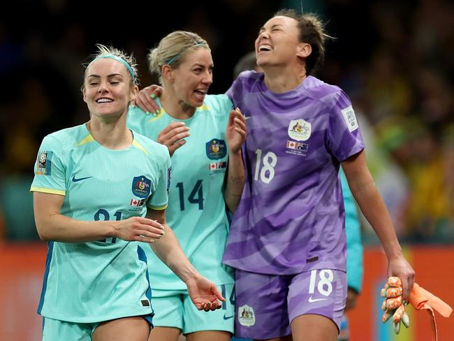 MELBOURNE, AUSTRALIA - JULY 31: (L-R) Ellie Carpenter, Alanna Kennedy and Mackenzie Arnold of Australia celebrate the team's 4-0 victory and qualification for the knockout stage following the FIFA Women's World Cup Australia & New Zealand 2023 Group B match between Canada and Australia at Melbourne Rectangular Stadium on July 31, 2023 in Melbourne, Australia. (Photo by Cameron Spencer/Getty Images)