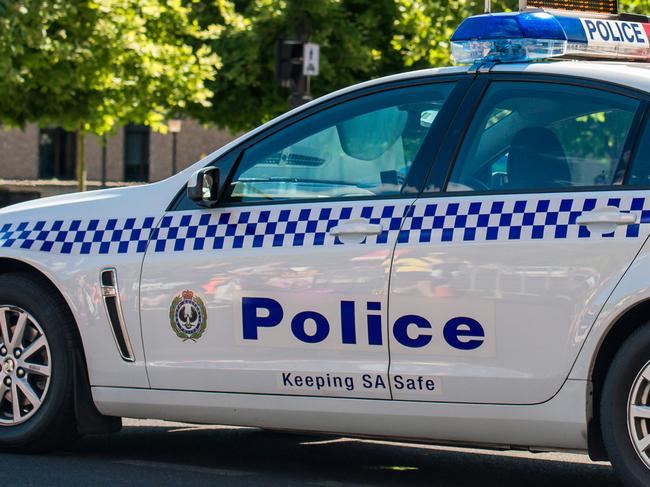 Adelaide: South Australian police car closed the street in Adelaide's CBD with the policeman patrolling on the background