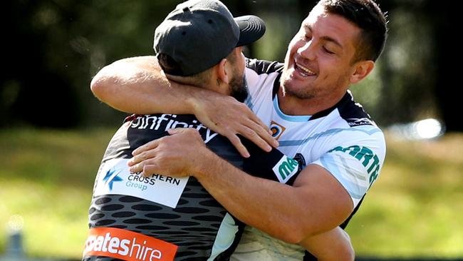 Bird gives Chris Heighington a hug during Sharks training. Photo: Gregg Porteous