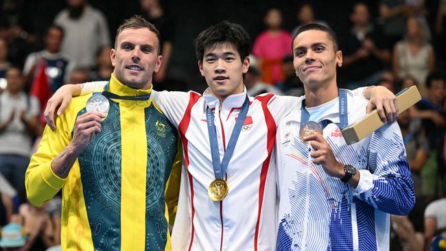 Kyle Chalmers copped abuse from the fans of China’s Pan Zhanle (centre). (Photo by Jonathan NACKSTRAND / AFP)