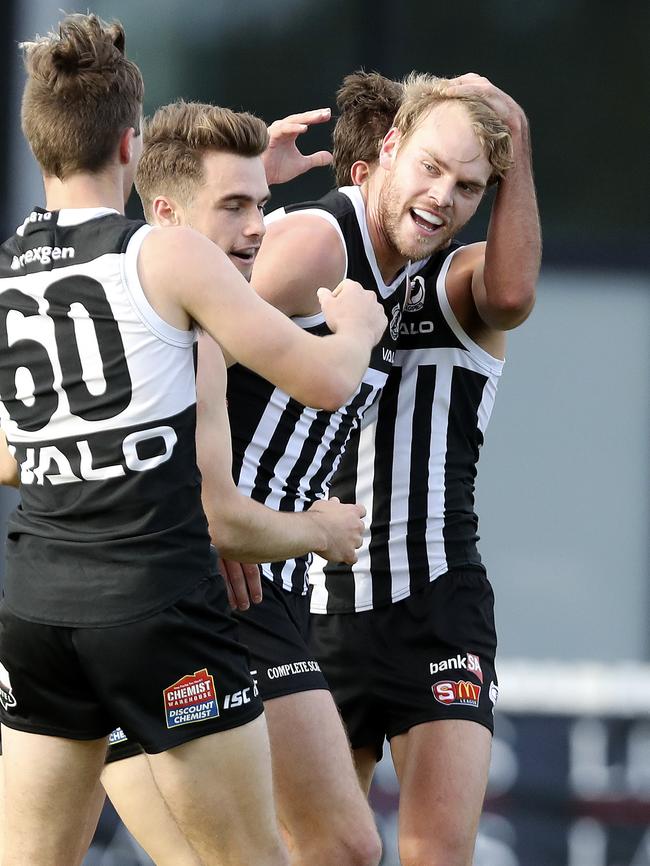 Jack Watts celebrates a goal with Port teammates during an SANFL appearance. Picture Sarah Reed