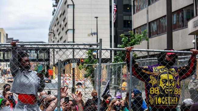 People gather outside the family justice centre during a press conference after a court hearing on the murder of George Floyd. Picture: AFP.