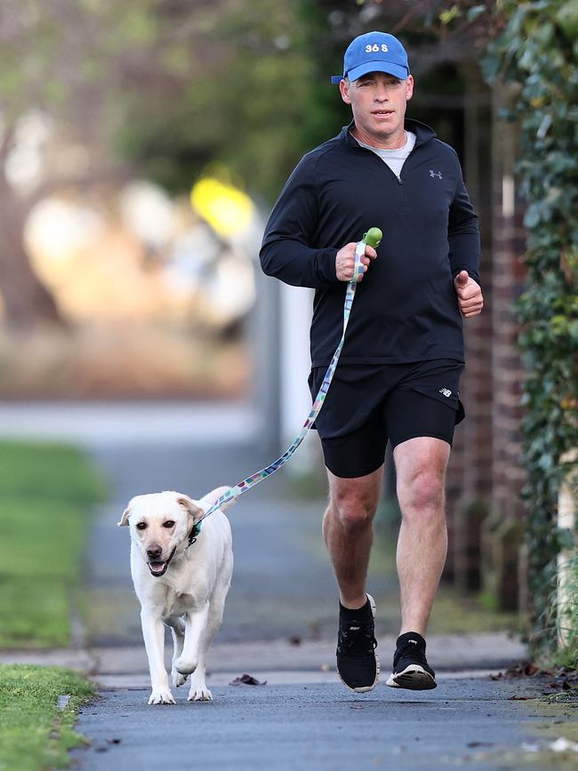 Alastair Clarkson out for an early morning run with his dog Beaver in Brighton this morning. Picture: Michael Klein