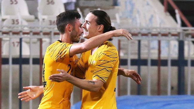 Australia's Apou Giannou celebrates a goal with teammate Jackson Irvine. Picture: AFP