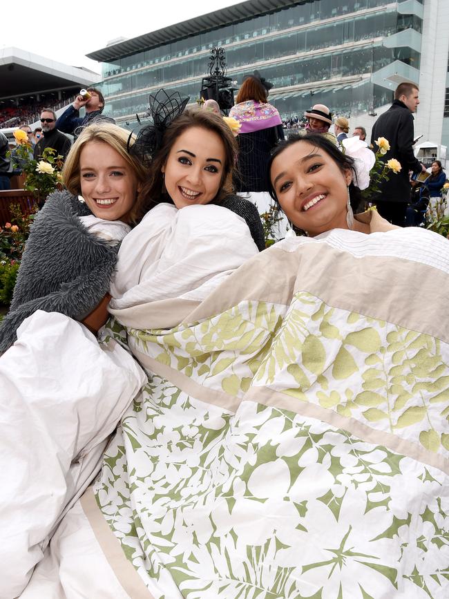 Harriet Kelsom, Annie Cox and Arusha Jayasekera keeping warm. Picture: Nicole Garmston