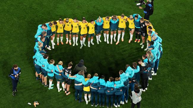 Australia players huddle after the team's 3-1 defeat to England. Picture: Getty