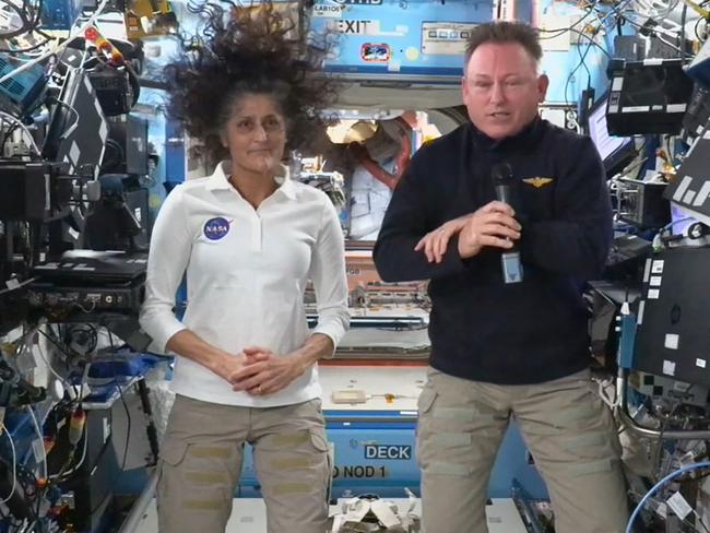 TOPSHOT - In this still image taken from a NASA TV broadcast, NASA astronauts Butch Wilmore (R) and Suni Williams hold a news conference from the International Space Station (ISS) on September 13, 2024. Wilmore and Williams, who arrived at the ISS aboard Boeing's Starliner, will return home with rival SpaceX in February 2025, NASA has said. (Photo by Handout / NASA TV / AFP) / RESTRICTED TO EDITORIAL USE - MANDATORY CREDIT "AFP PHOTO / NASA TV" - NO MARKETING NO ADVERTISING CAMPAIGNS - DISTRIBUTED AS A SERVICE TO CLIENTS