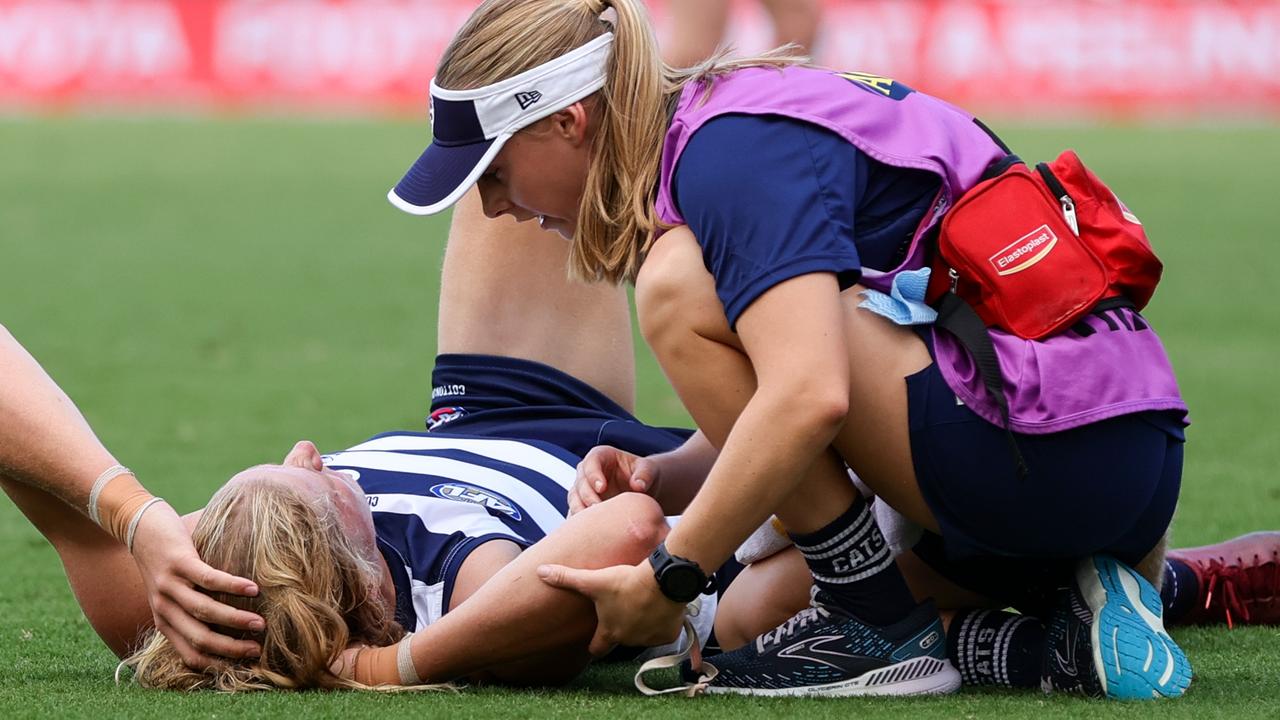 Sam De Koning is assisted after a heavy head clash. Picture: Russell Freeman/AFL Photos via Getty Images