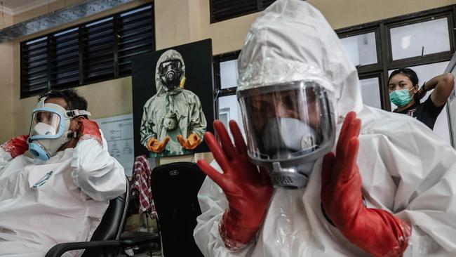 Indonesian volunteers and medical personnel wearing personal protective equipment in Yogyakarta, Indonesia. Picture: Getty Images