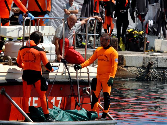 Divers recover bodies from the yacht last month. Picture: AFP