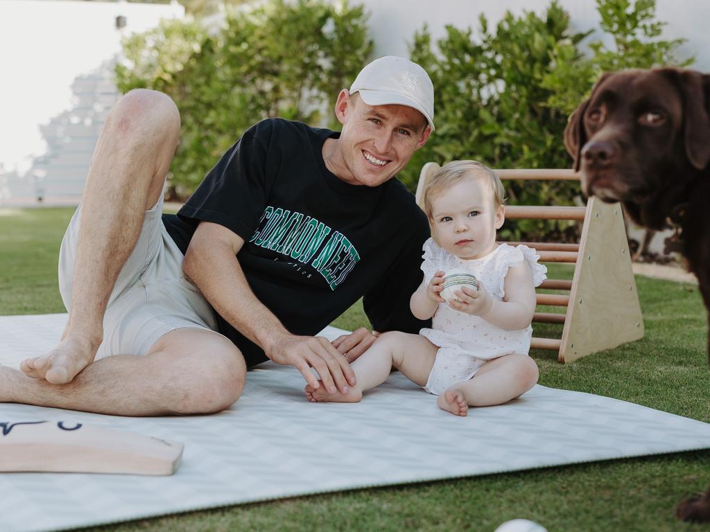 Marnus Labuschagne and his daughter Hallie at home with a ball and his dog Milo. Picture: Matthew Gillam.