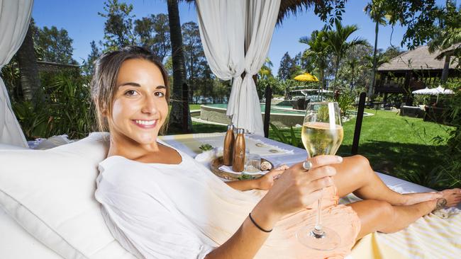 Maria Bravo relaxes under a gazebo by the pool with champagne at a rejuvenated Makepeace Island. Photo Lachie Millard