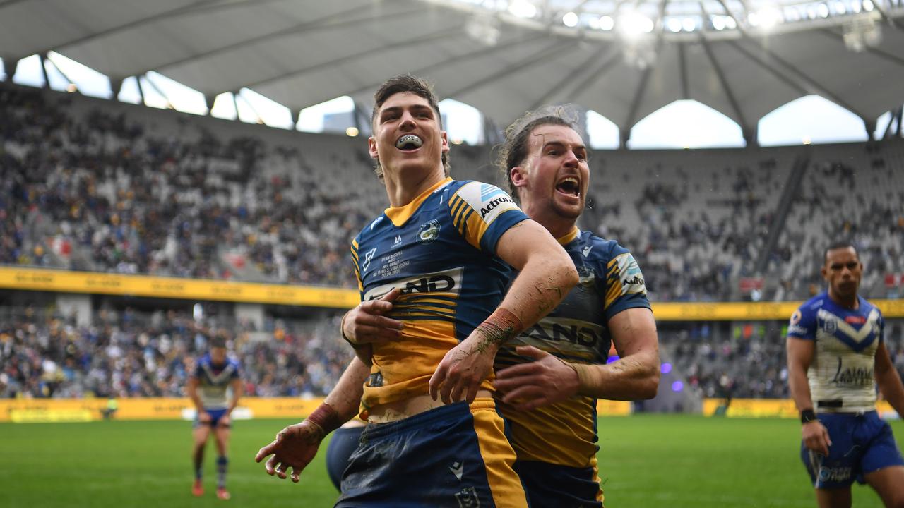 Russell celebrates one of his three tries against the Titans.