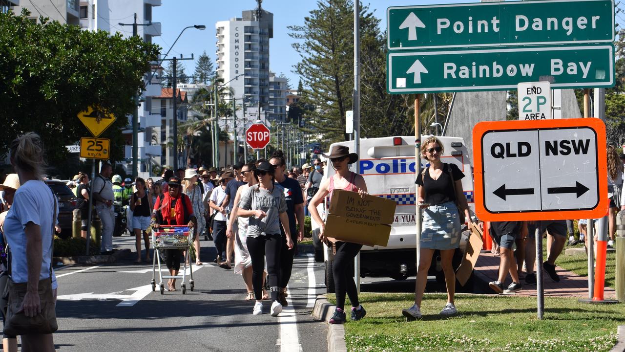 Protesters walk down Queensland side of the border at Point Danger. Photo: Liana Walker