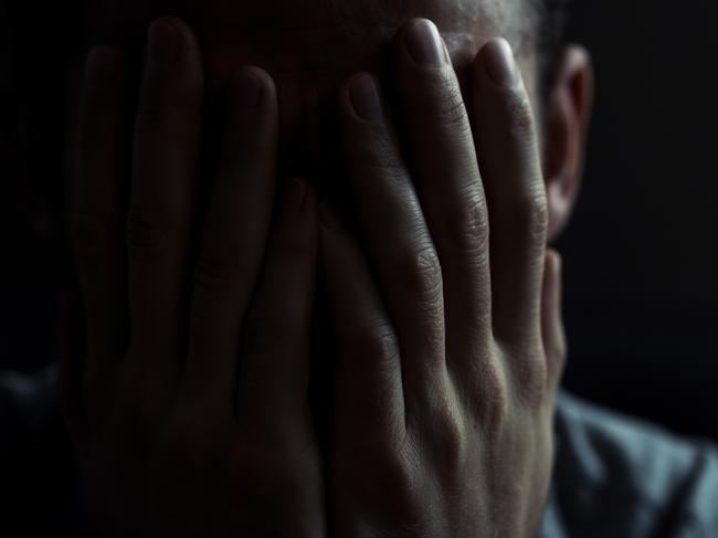 Portrait of a man in dark room. Depression concept.