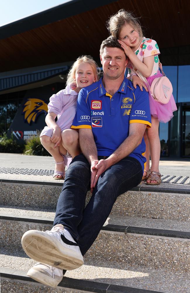 Andrew McQualter poses with his daughters Emily and Alice after being announced as Eagles coach. Picture: Paul Kane/Getty Images.