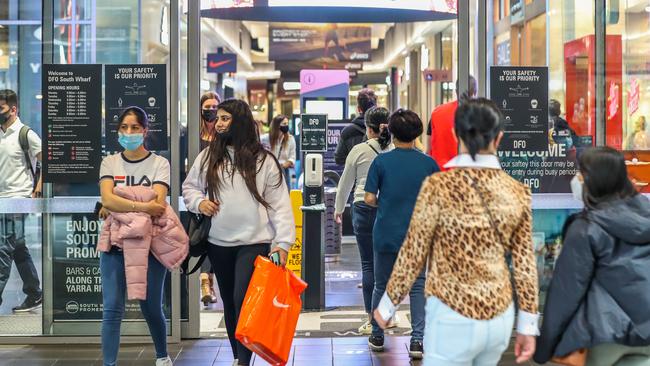 Shoppers are seen entering and exiting a mall on Friday. Picture: Getty Images