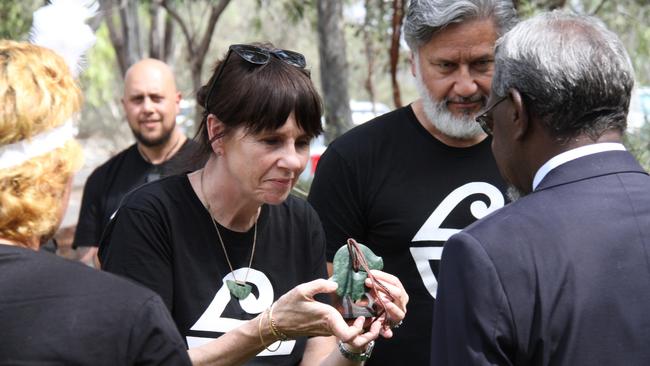 Air New Zealand's Kiri Hannafin and Tupara Morrison hand over the taonga to Arrernte Elders Benedict Stevens and Rosalie Ngkwarraye Riley at Alice Springs Airport, October 7, 2024. Picture: Gera Kazakov